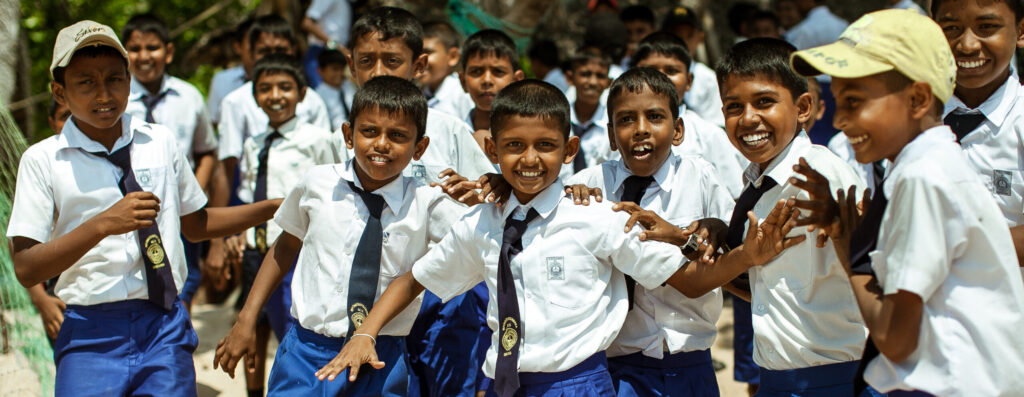 School children dressed in uniform have fun and play in the schoolyard.